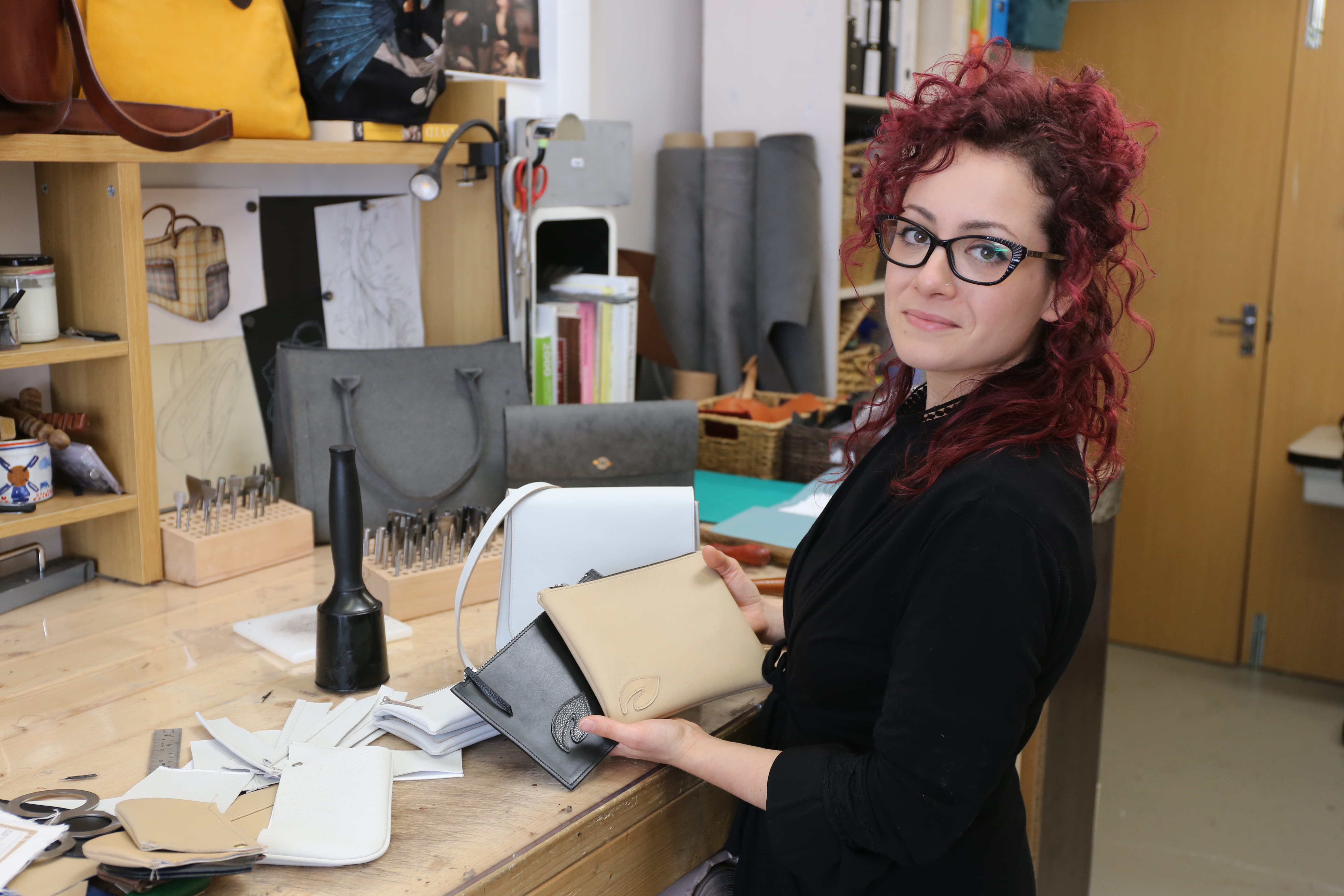 Sara Battiston, founder of the London Leather Workshop, displays accessories made with MIRUM.